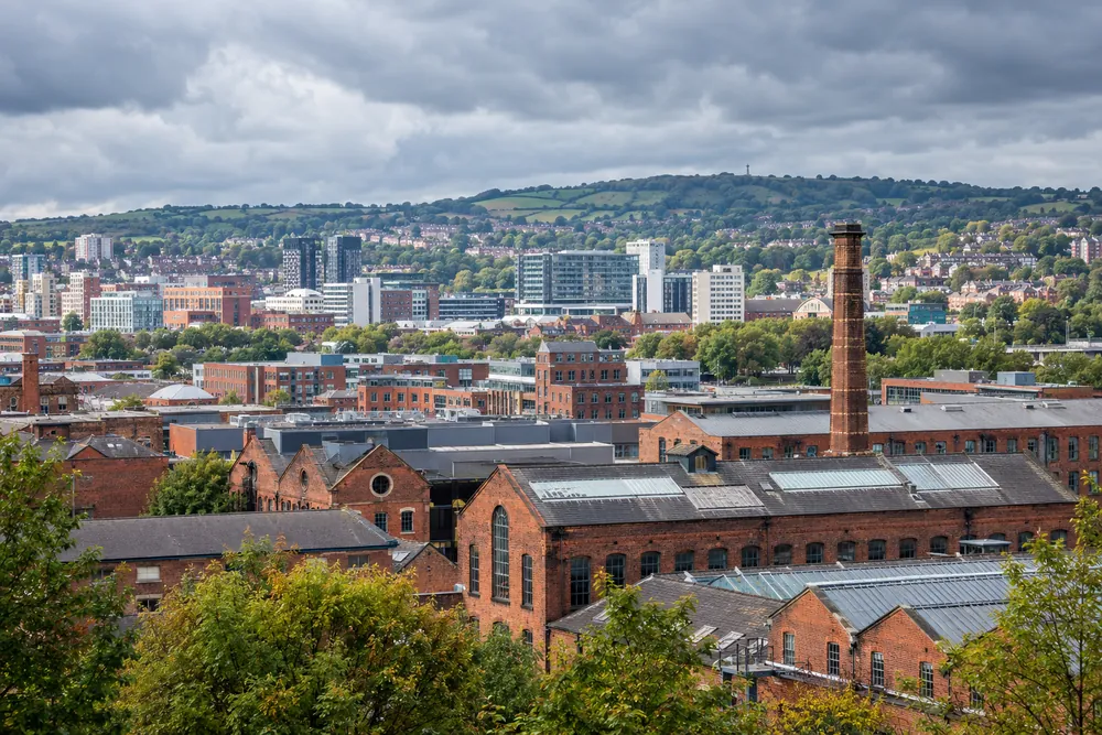 Brick workshops beneath green hills illustrating commercial premises around Sheffield and South Yorkshire